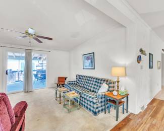 Couch, end tables, lamp, school desk