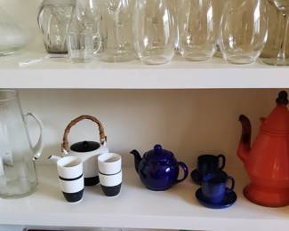 Various tea pots, coffee pots, espresso cups, glass pitchers