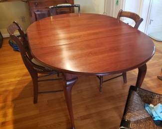 Beautiful vintage dining room table. Has one more leaf to extend to fit 8-10 and protective cover; $400