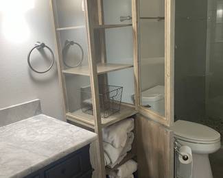 #99 - $150 - Tall bathroom cabinet 3 glass shelves opened on each side. 