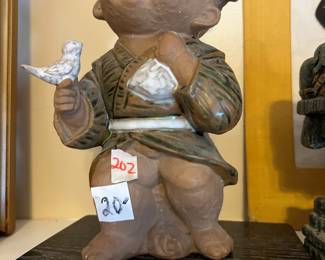 #202 mudkid holding bird, 10" tall $20.00