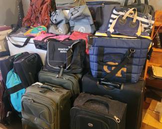 Lots of suitcases, coolers, and back packs