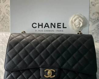 Sold - Chanel Handbag in Caviar Leather - Pre-owned - never used - Sold                                                       
Chanel Black Caviar Maxi Double-Flap Shoulder Bag 2013  Collection
Gold- Tone Hardware
Chain- Link Shoulder Straps
Canvas Lining
Turn- Lock Closure at Front  