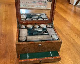 Burlwood box with travel toiletry items fitted interior.