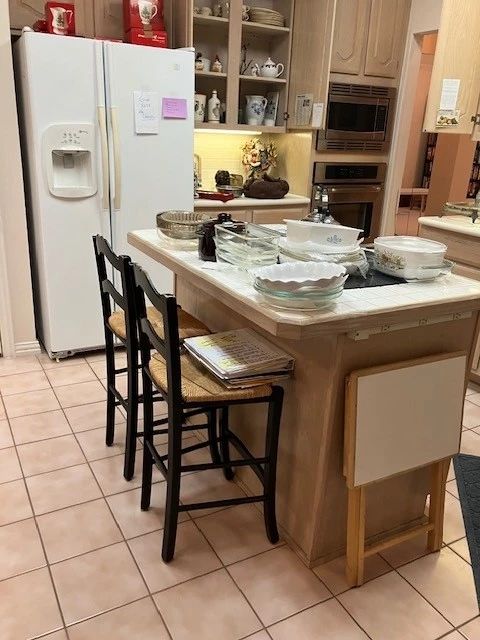 Full kitchen, great bar stools.  Maytag side by side fridge