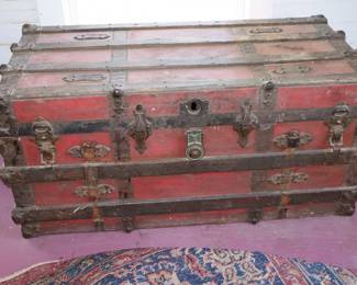 Large, trunk with red canvas body cover, this is a conversation piece...maybe a coffee table in the master bedroom. 