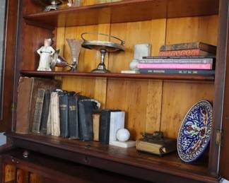 Inside of the secretary bookcase top and cylinder desk in the living room.
