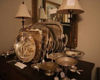 Silverplate trays and buffet lamps on chest in dining room.
