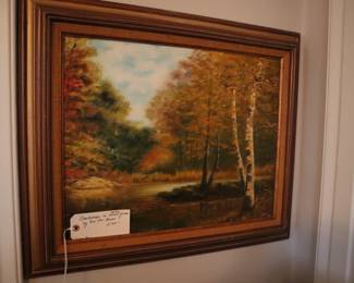 An oil painting of landscape, framed, by Eva Sue Burns, in the living room.