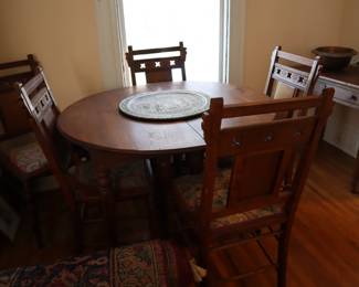 Round kitchen table with 6 chairs available in the lower staircase room.