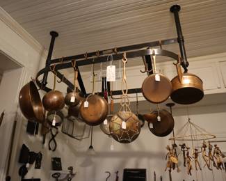 A custom iron pot hanger in the kitchen. The African mobile is on the right of the photo.