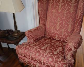 Wing chair with simple feet in living room.