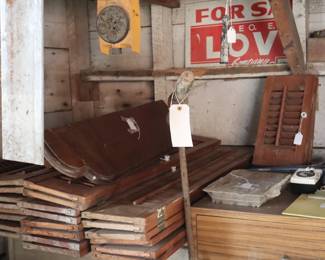 Sets of shutters that have been removed from the windows. In the garage.