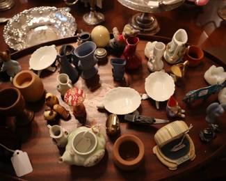 Tiny items displayed on a wooden oval tray on top of the dining table.