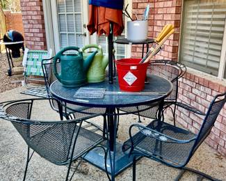 METAL PATIO TABLE WITH 2 ARM CHAIRS AND 2 SPRING CHAIRS.