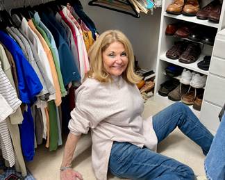 Kim working in the closet getting the clothing ready. 