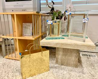 Waterford, Wedgewood, and unmarked heavy glass picture frames on heavy travertine coffee table. Brass magazine rack. Rotating TV stand.