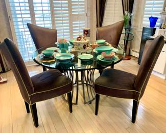 Modern Shaver Howard metal pedestal glass top dining table. Micro fiber gray modern chairs. Fritz and Floyd Aqua and Pink dish's