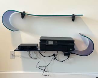 (2pc) Glass Wall Shelves | Two color glass wall shelves in blue and purple, can be displayed in multiple configurations; n.b. electronics not included. - h. 10.5 x l. 39 x d. 11 in (each)