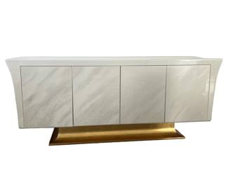 MODERN LACQUERED CONSOLE | Contemporary style credenza / sideboard cabinet in a lacquered faux marble with curved sides over a gilt base, having two sets of cabinet doors, the left interior with shelf, the right interior with drawer. - h. 32.75 x l. 80.5 x d. 20 in