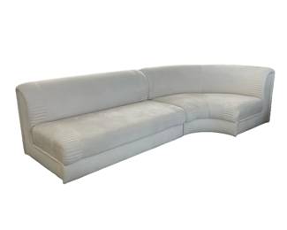 CONTEMPORARY SECTIONAL SOFA | Overall ultra suede creme colored upholstery, two sections including a straight and a curved corner piece, pairs with corner loveseat (lot #7); depth 34 in., seat height 16 in.; each section length 58 in. and length 49 in. - h. 30 x l. 110 x d. 44 in (overall)
