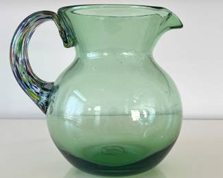 Blown Glass Pitcher | Green blown glass pitcher with colorful art glass handle. - h. 8 x dia. 5.5 in ((at top of pitcher)
