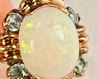 10K gold ring with an oval shaped opal and four round aquamarine stones (tested). 
