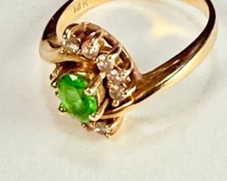 14K gold ring with an oval green peridot and 10 seed diamonds (tested). The ring is a size 7,