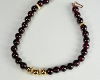 14K gold bracelet with garnet and gold beads.