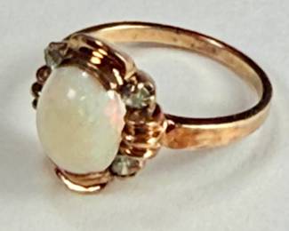 10K gold ring with an oval shaped opal and four round aquamarine stones (tested). 