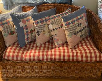 Little wicker sofa & quilt pillows. 