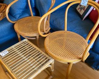 Bowed rattan chairs with cane seat. Small wicker & glass table ( there is actually 2 of this little table) 