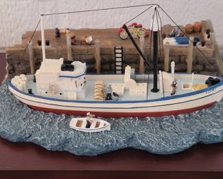 Several boat models, some encased in glass or plastic