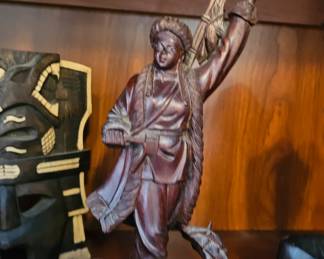 Hand carved  statue of a Chinese fisherman, likely made of rosewood. 