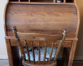003 Roll Top Desk With A Chair And Some Decor