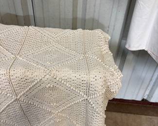 Several hand made lace table cloths and bed spreads