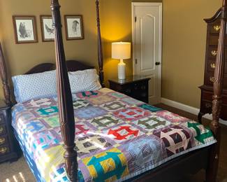 Lovely bedroom suite accented with cool quilt.