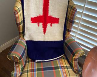 Cool airplane blanket on funky plaid chair.