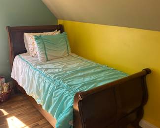 Cute little twin sleigh bed.