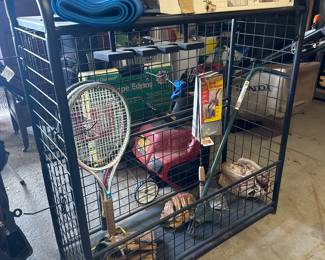 Sports equipment stand, tennis rackets, baseball gloves, and bats