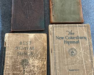 Four old leather hymnals and poem books