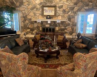 Stunning living room furniture.  Pair of arched hunter green leather couches, armchairs, large round coffee table, large run, brown leather sofa