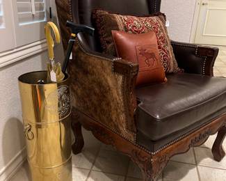 Brass umbrella stand, leather and hide armchair