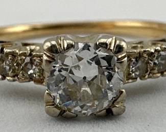 Size 8.5 vintage diamond ring is set in 14kt gold with center Old European cut round stone (0.58ct, H color, SI1 clarity) and two smaller stones on each side