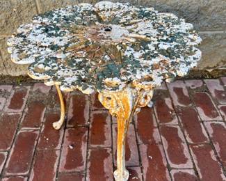 Cast iron round garden table, signed underneath with eagle and arrow