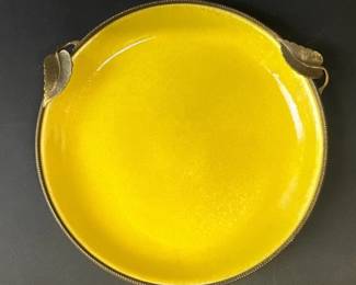 Vintage yellow enamel plate has faint tone on tone design with brass leaf roped rim