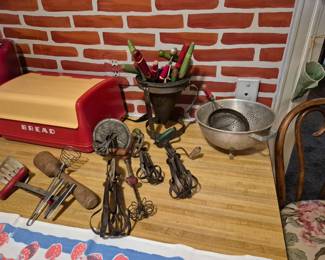 Vintage egg beaters. Retro bread box. Old ricer. Vintage wood handled kitchen utensils.