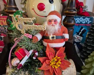 Santa in front. Wind up musical Snowman head in back.