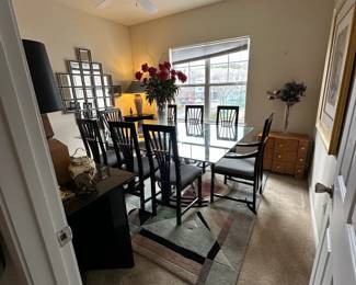 A3 - $200. Chrome Sawhorse Base with LARGE Glass top. Glass measures 5' x 7'. You will need a couple STRONG people to move the glass out! Includes 6 regular chairs. 2 arm chairs.