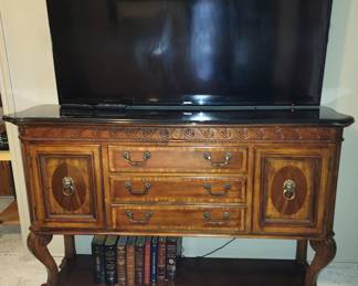 Elegant carved mahogany buffet with lion head pulls. 65" Samsung flat screen tv